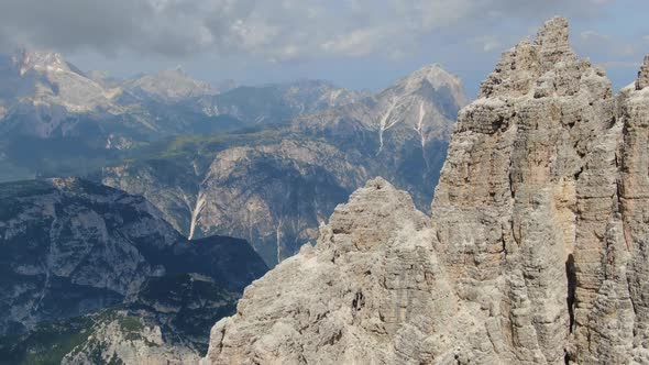 Flying close to the characteristic mountain peaks in Dolomites, Italy, Europe alt