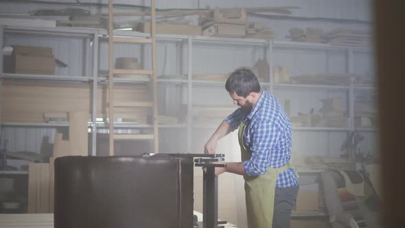 Male Professional Furniture Maker Assembles the Chair in the Workshop alt