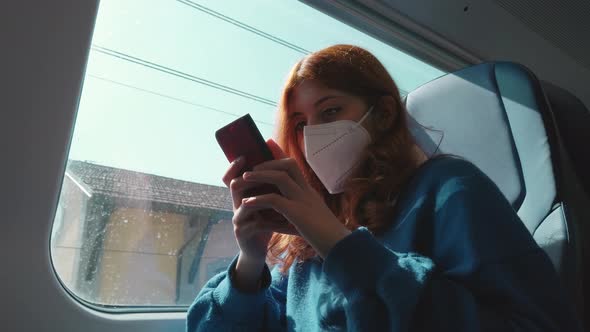Girl Sitting on Train Using Smartphone alt