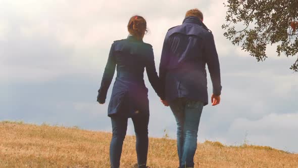 Beautiful Couple Holding Hands, Walking Together on Hill, Autumn Date Outdoors alt