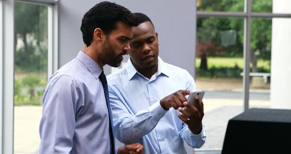 Executives using mobile phone alt