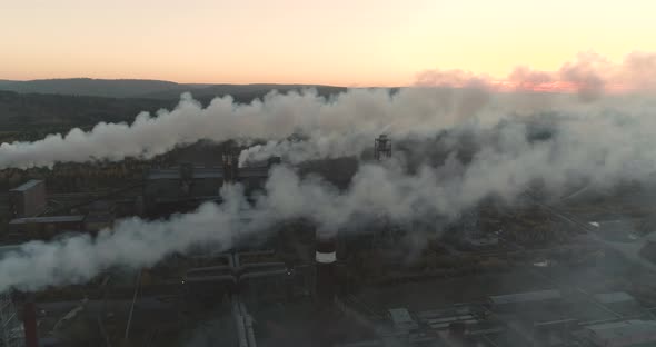 Aerial View Emission to the Atmosphere from Industrial Pipes Smokestack Chimneys. alt