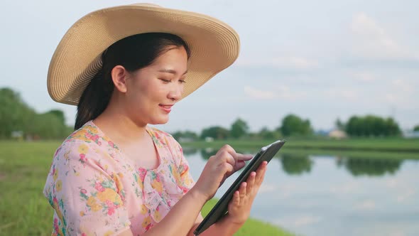 Asian woman using portable device during vacation. Portable technology concept. alt