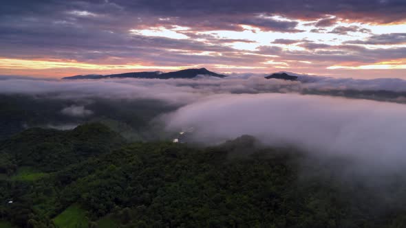 Hyper lapse Drone flight over the clouds during sunrise.