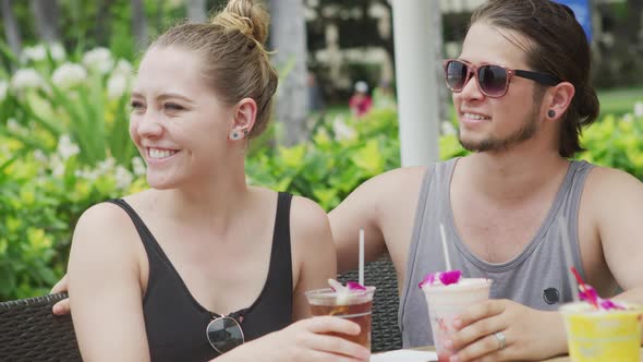 Couple in Hawaii having cocktails