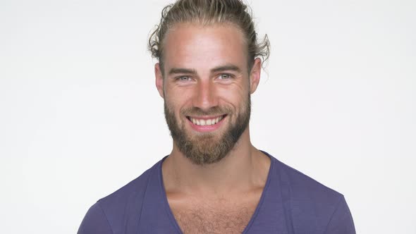 Closeup Caucasian Handsome Man Wearing Blue Tshirt Looking at Camera Smiling Broadly with White alt
