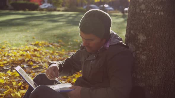 College student on campus using laptop computer