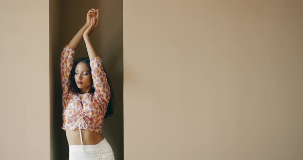 Model Girl Posing for Photoshoot on Wall Background