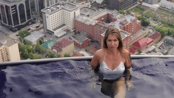 Attractive Woman in Swimming Pool on Roof