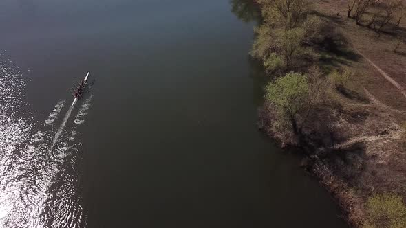  Four People Rowing of Black Water