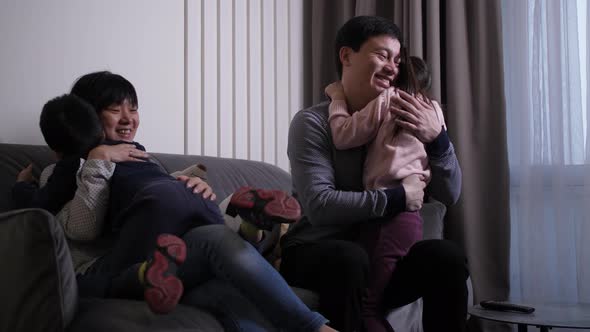 Loving Children Hugging Happy Parents Indoors alt