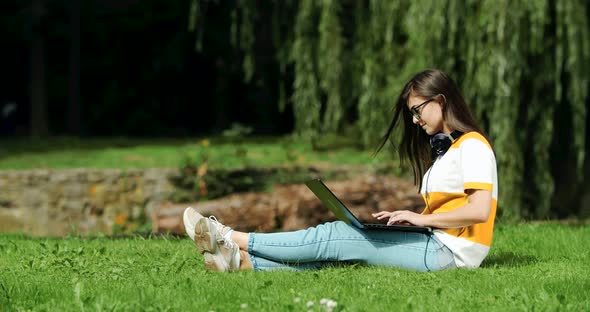 Woman Working on Laptop in Park