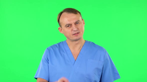 Medical Man Threatens with a Finger and Waves Her Head Negatively. Green Screen alt