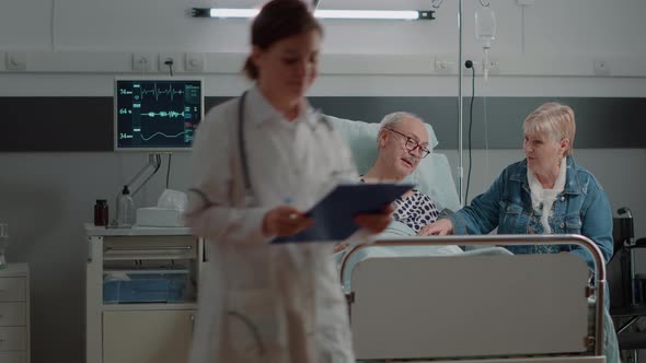 Child and Daughter of Sick Patient Coming to Visit in Hospital Ward alt