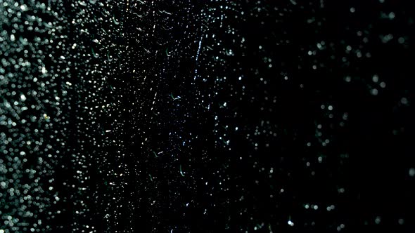 Water droplets run down the glass alt