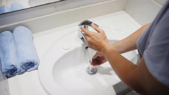 Hands Washing with Foam Water Flows Through the Hands alt