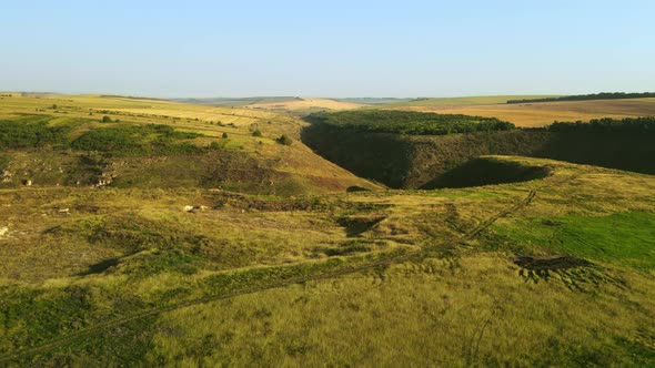Aerial drone view of nature in Moldova. Valley with green hill slopes, fields alt
