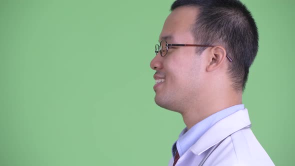 Closeup Profile View of Happy Asian Man Doctor with Eyeglasses Smiling alt