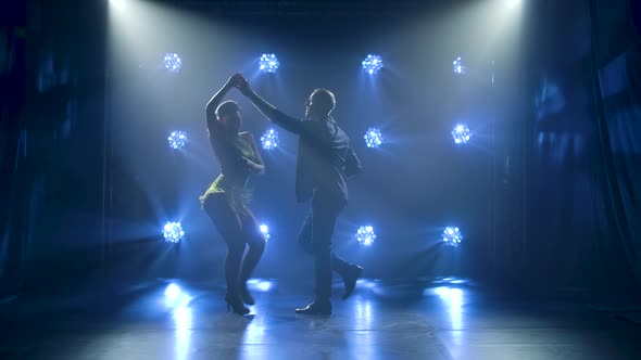 Concept of Social Dance and Relationships, Silhouette of Young Beautiful Couple Dancing Sensual alt