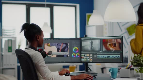 African Video Editor Looking at Camera Smiling Editing Video Project alt