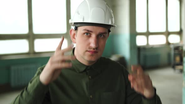 An Engineer Puts a Safety Helmet on His Head on Site alt