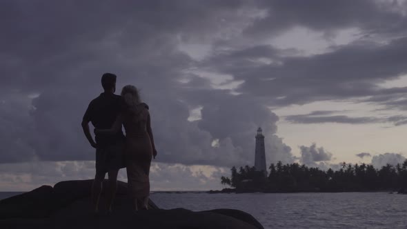 Couple Looking At Lighthouse