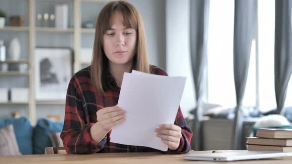 Casual Young Girl Reading Documents, Paperwork alt