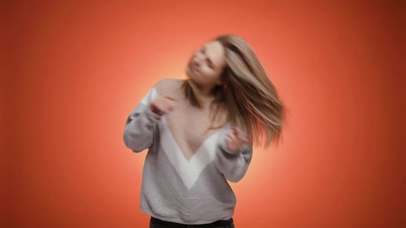 Extremely Happy Blonde Young Woman in Hoodies Dancing Joyfully Enjoying Music