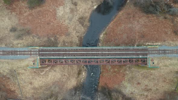 AERIAL: River Flows Below Old Railroad Bridge in Lithuania alt