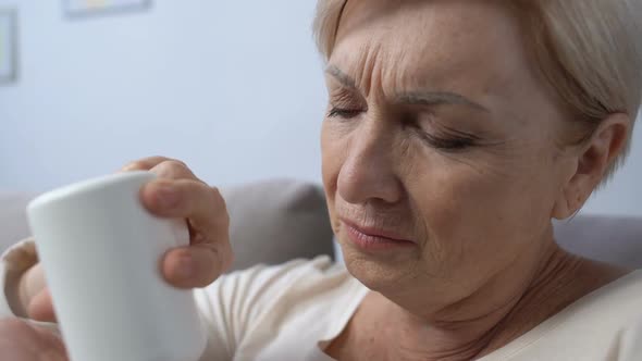 Elderly Woman Suffering From Pain Taking Painkiller, Health Care, Pharmacy