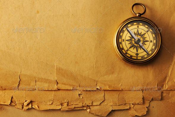 Antique brass compass over old background - Stock Photo - Images