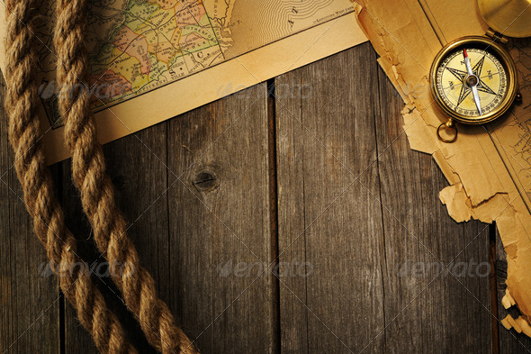 Antique compass and rope over old map - Stock Photo - Images