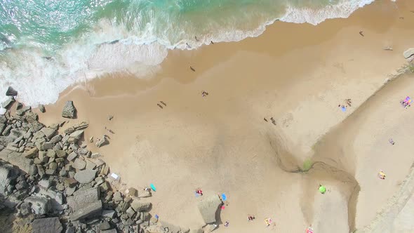 Aerial view of beach and cliffs next to Azenhas do Mar Village. alt