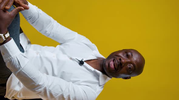 AfricanAmerican Man Says Something Looking Into the Camera on Yellow Background