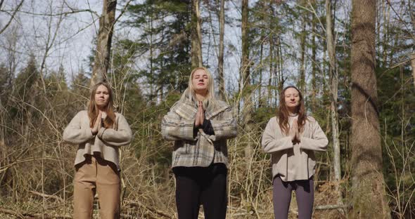 three girls meditate in nature breathe synchronously, inhale exhale alt