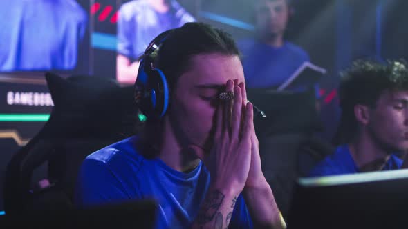 Anxious Gamer Warming Up Hands Before Match alt