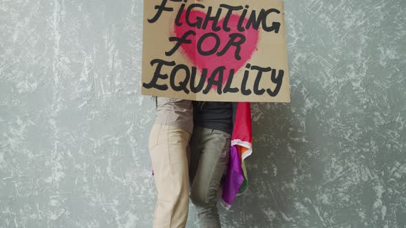 Young Women Raising High the LGBT Poster alt