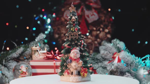 New Year's candle with a snowman on the background of New Year's toys alt