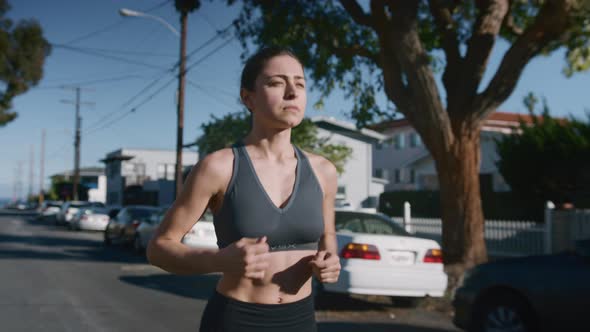 Shot of Sporty Fit Young Woman Running Outdoors
