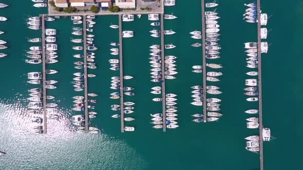 Bird eye view from drone of yachts and sailboats in the harbor marina. alt