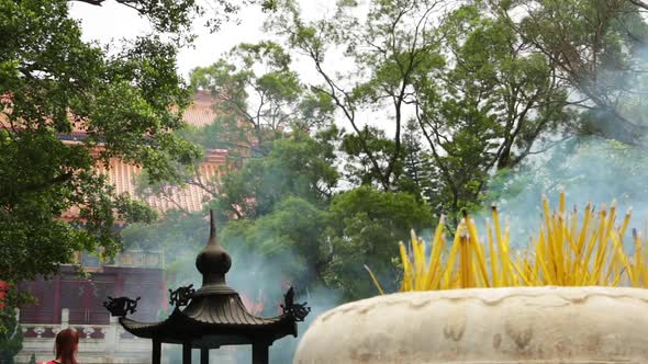 Religious Sticks Smoke in Front of Buddhist Temple