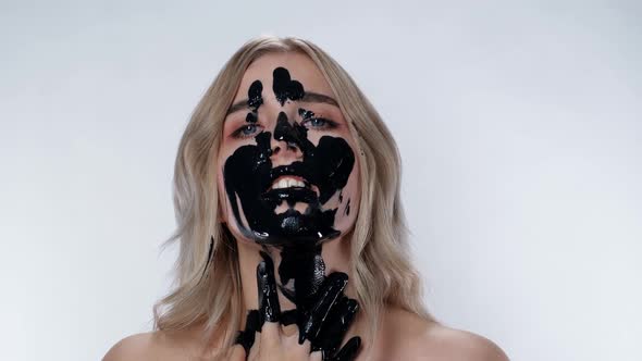 Charming Blonde Girl Applies Cosmetic Mask Environmental Pollution. Black Oil. alt