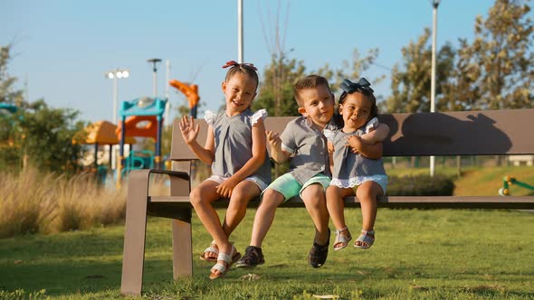 Funny happy children siblings playing in the park alt