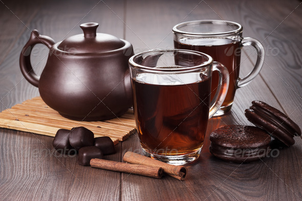 Cup Of Tea With Cinnamon Sticks And Teapot On The Table - Stock Photo - Images