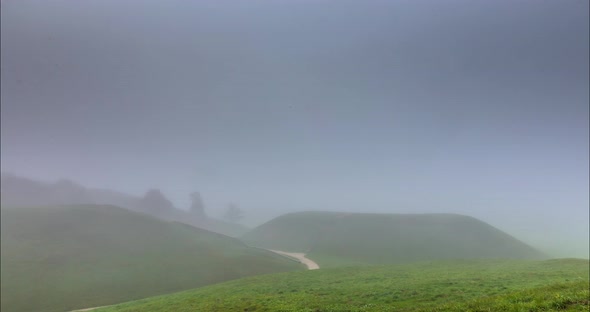 Fog Moving Over the Mounds in Kernave, Lithuania alt