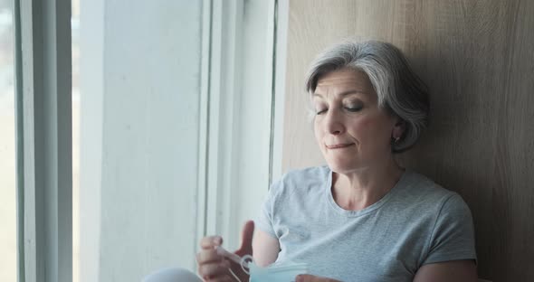 The Elderly Mature Old Woman Removing Her Mask and Breathing Freely with Joy Fully Recovered alt