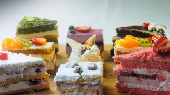 Pieces of Different Cakes on a Retrostyle Baking Tray alt