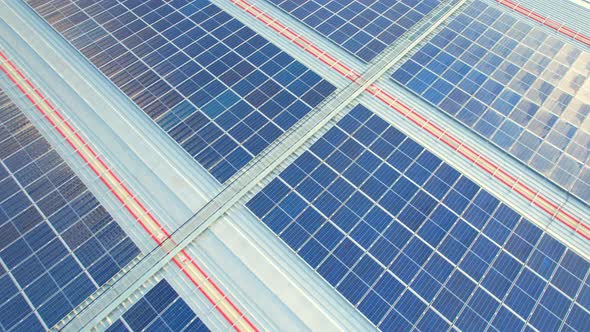 Aerial cinematic view of a solar panel on mall roof top alt
