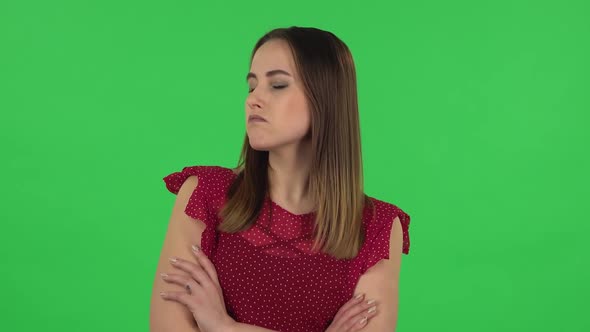 Portrait of Tender Girl in Red Dress Is Very Offended Then Smiling. Green Screen alt