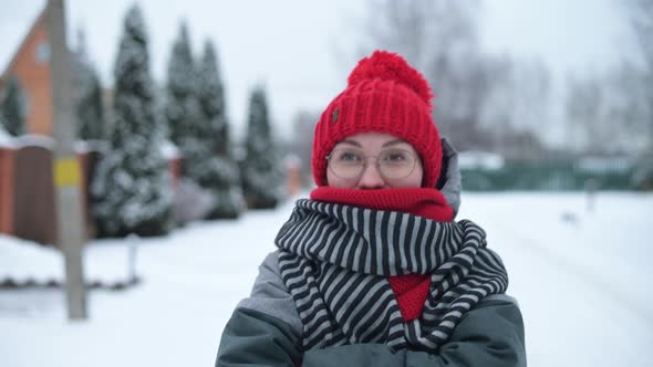 Young woman walking down the street on a frosty winter day alt
